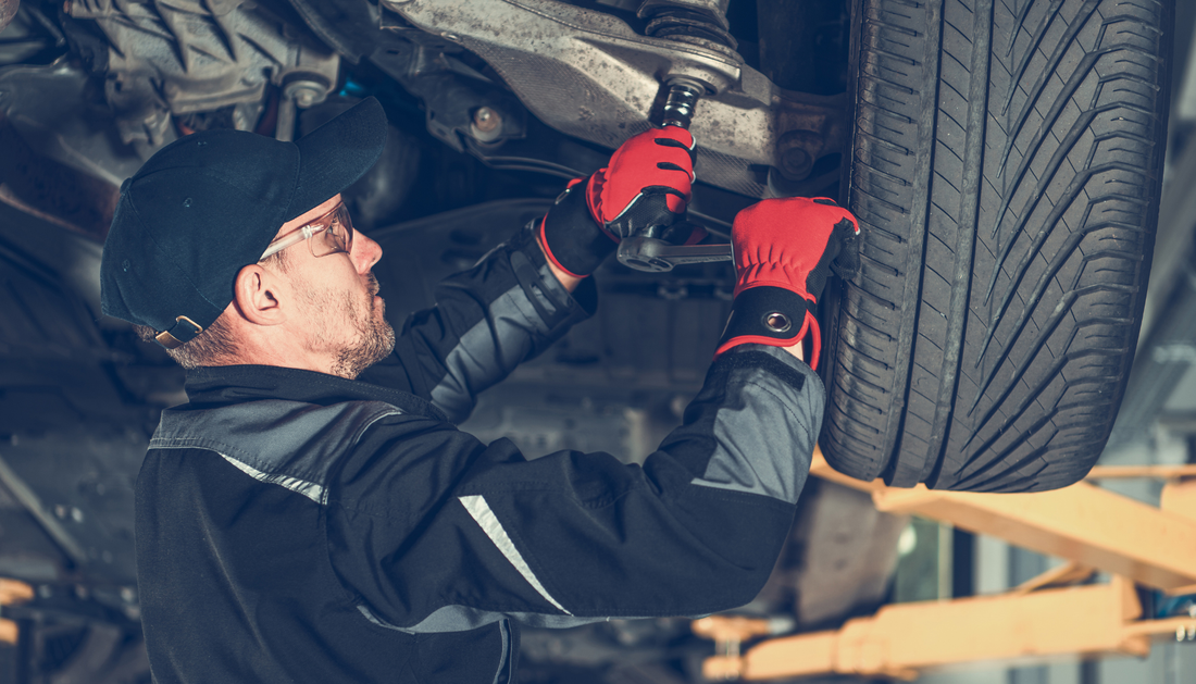mechanic working on a vehicle in a garage