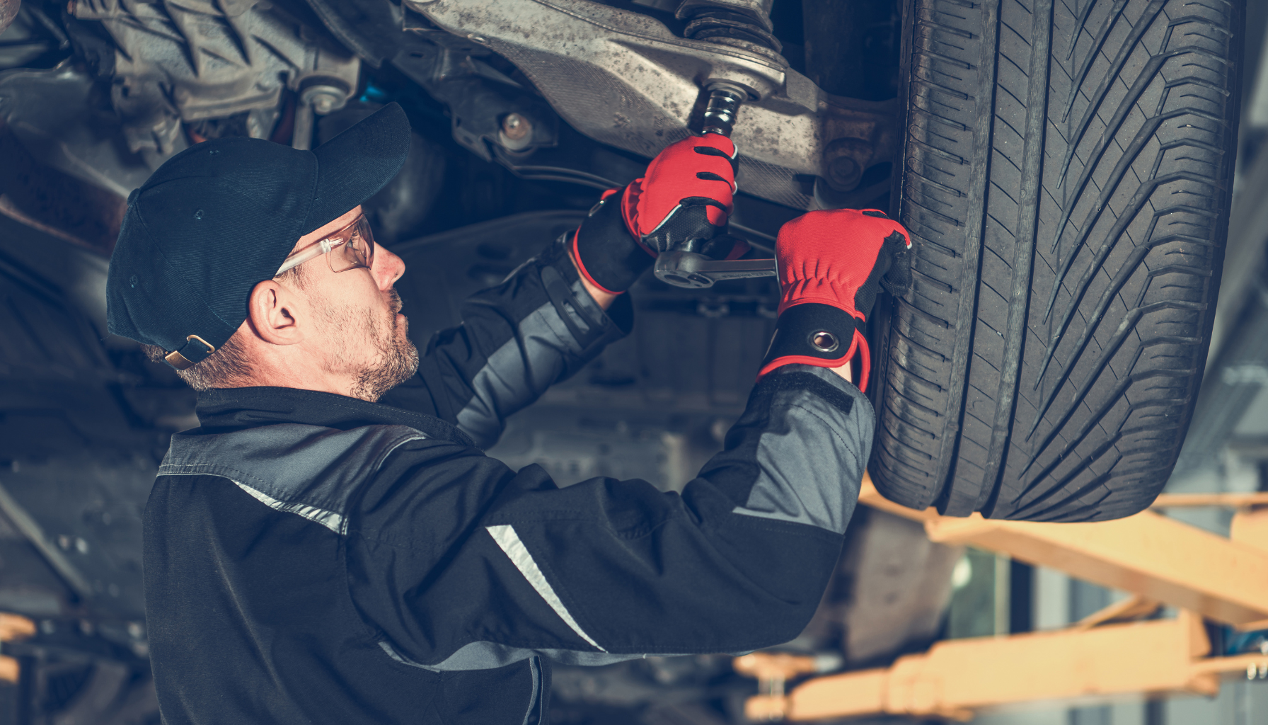mechanic working on a vehicle in a garage